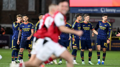 Dejected Arsenal players look on as Fleetwood players celebrate