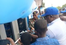 Mr Amegashie (in cap) cutting the tape to inaugurate the centre