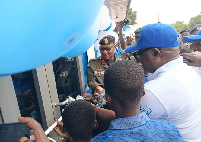 Mr Amegashie (in cap) cutting the tape to inaugurate the centre