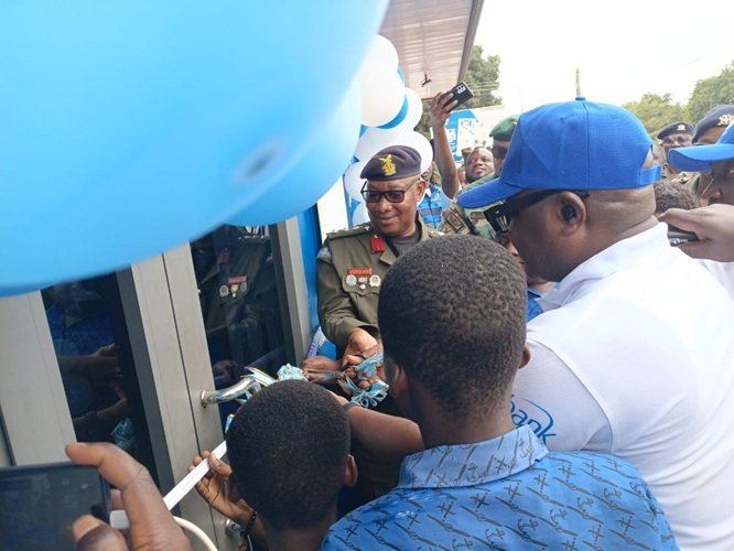 Mr Amegashie (in cap) cutting the tape to inaugurate the centre