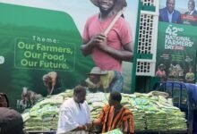 Mr Dumelo (left) receiving the items