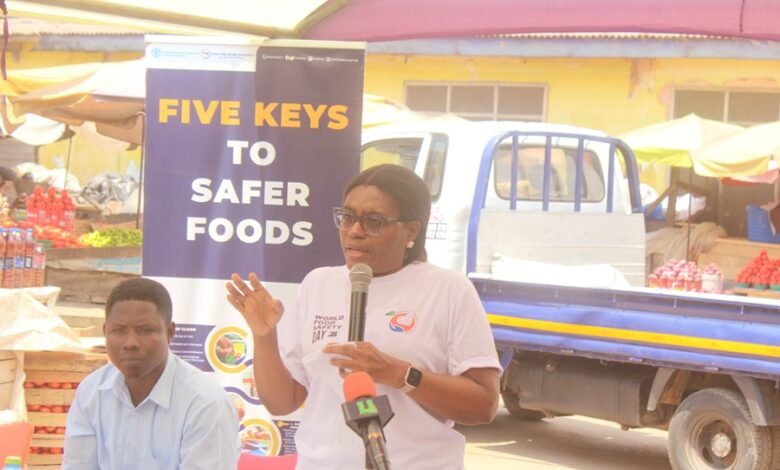 Mrs Maureen Lartey (inset) addressing traders at the Mallam Atta Market in Accra. Photo. Ebo Gorman
