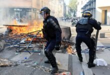 French riot police officers clash with protesters in Lyon