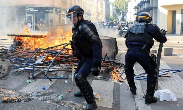 French riot police officers clash with protesters in Lyon