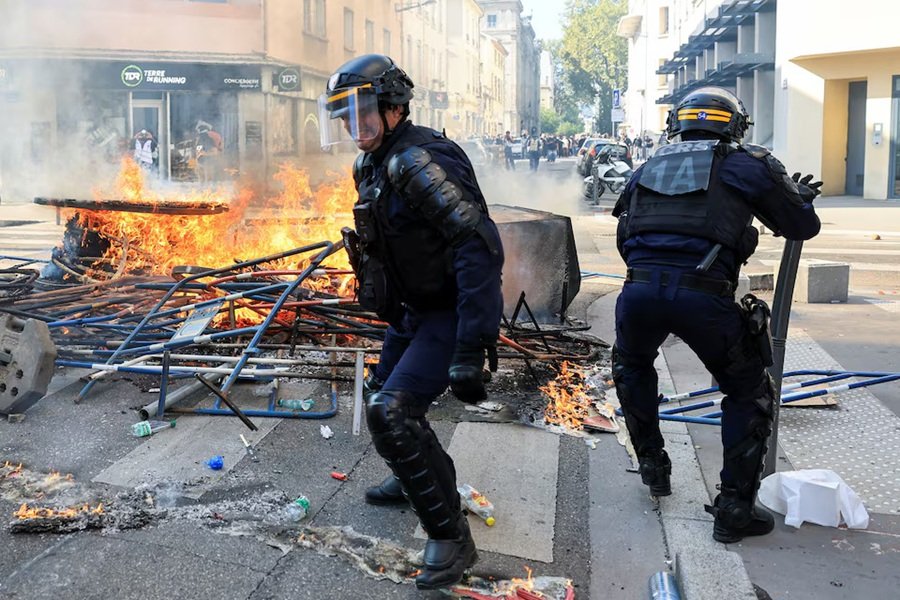 French riot police officers clash with protesters in Lyon
