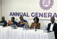 Dr Afriyie (middle) speaking at the programme. With Mrs Ofosu-Adjare (second from left) and other dignitaries at the event