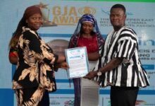 Ms Rafia Abdul-Razak (left) receiving the award on behalf of Mr Francis Dabang at the event
