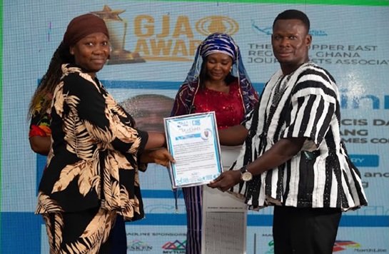 Ms Rafia Abdul-Razak (left) receiving the award on behalf of Mr Francis Dabang at the event