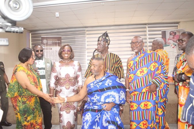 Ms Linda Ocloo (left) exchanging greetings with Ga Mantse, King Tackie Teiko Tsuru II (seated). Looking on is Ms Obuobia Darko-Opoku, Administrator, GMTF