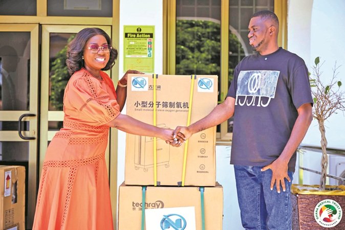 Ms Obuobia Darko-Opoku (left) presenting the items to a beneficiary representative at the event