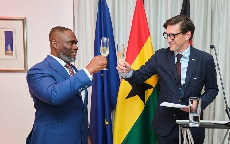 Mr Landscoft (right) and Mr Adjei proposing a toast during the reception