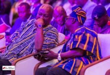 President Mahama (left) in a discussion with Mr Hoetu at the National Housing Finance Conference