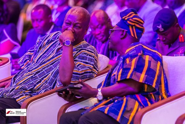 President Mahama (left) in a discussion with Mr Hoetu at the National Housing Finance Conference