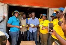 MTN staff presenting a gift to a customer
