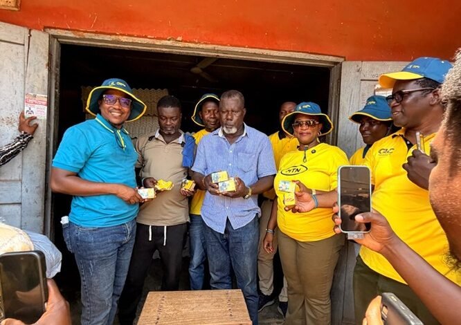 MTN staff presenting a gift to a customer