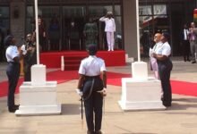 Mr Gyakye Quayson (left) and Mr Choudhury being assisted by military personnel to hoist the flags. Photo Ebo Gorman