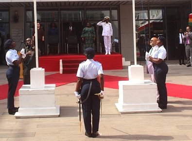 Mr Gyakye Quayson (left) and Mr Choudhury being assisted by military personnel to hoist the flags. Photo Ebo Gorman
