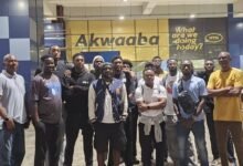 Mr Kukula (right) with the players and officials at the airport