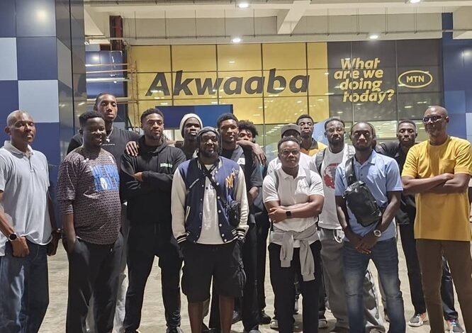 Mr Kukula (right) with the players and officials at the airport