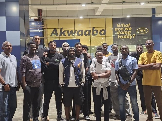 Mr Kukula (right) with the players and officials at the airport