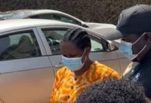 Ms Salomey Baffoh being escorted by a police officer