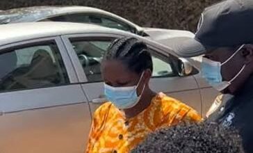 Ms Salomey Baffoh being escorted by a police officer