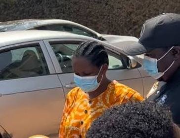 Ms Salomey Baffoh being escorted by a police officer