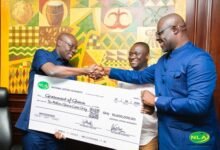 Alhaji Abdul-Salam (right) presenting the cheque to Dr Forson during the programme