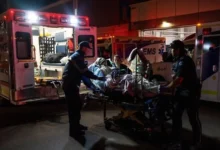 Paramedics load an injured person into an ambulance at the Wainwright Health center