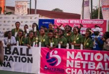 Players and officials of Hunters Hand celebrating with the trophy