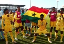 Players and officials of the Black Maidens celebrating their qualification