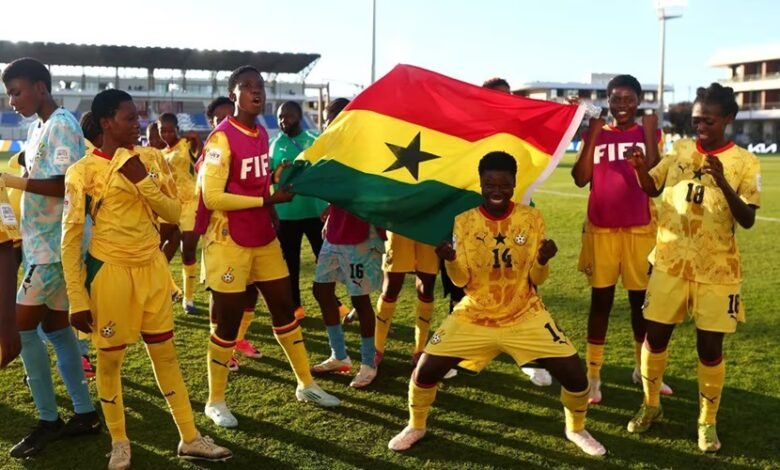 Players and officials of the Black Maidens celebrating their qualification