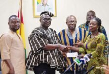 Mr Opoku (second from left) presenting a cheque to one of the beneficiaries