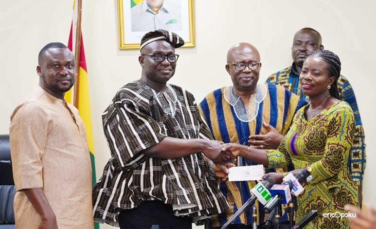Mr Opoku (second from left) presenting a cheque to one of the beneficiaries