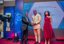 Mr Ahmed Tetteh (middle) receiving the award on behalf of the Ministry