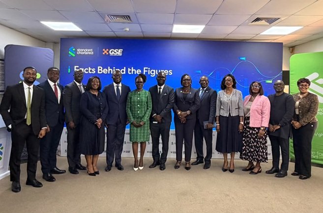 Mr Godzi (second from left) with Ms Amoah (third from left) and some senior officials of Standard Chartered Bank.
