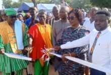 Ms Diana A. Ayamga (second from right) joined by Naba Baba Salifu (left) and other dignitaries to cut the tape to officially open the facility