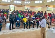 Mr Fynn (infront) addressing participants at the meeting