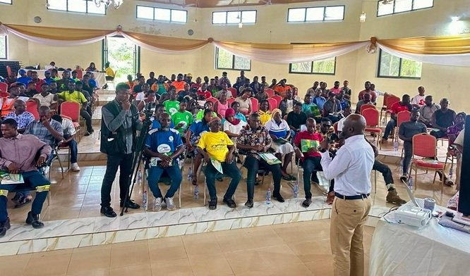 Mr Fynn (infront) addressing participants at the meeting