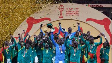 Senegal's Sadio Mane lifts the trophy with teammates as they celebrate after winning